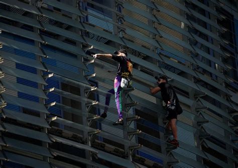 French Spiderman climbs first skyscraper with son in Barcelona, World ...