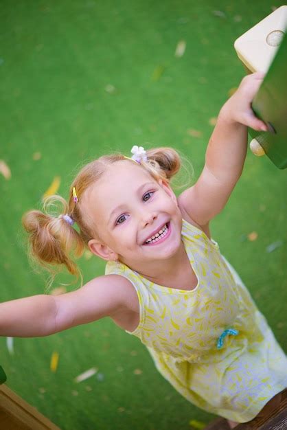 Premium Photo Portrait Of Smiling Girl Standing Outdoors