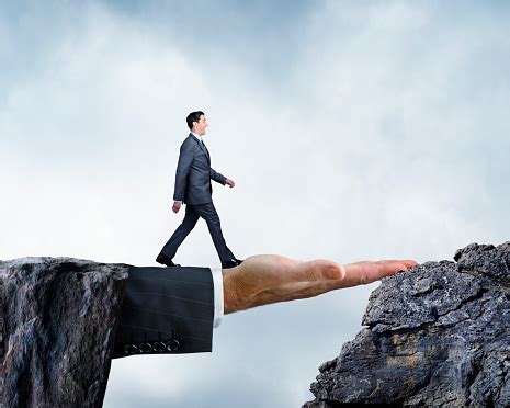 Businessman Walking Across Bridge Created By Large Hand Stock Photo ...