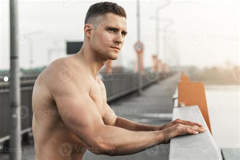Muscular Man With Naked Torso During Fitness Workout On A Bridge Stock Photo At Vecteezy