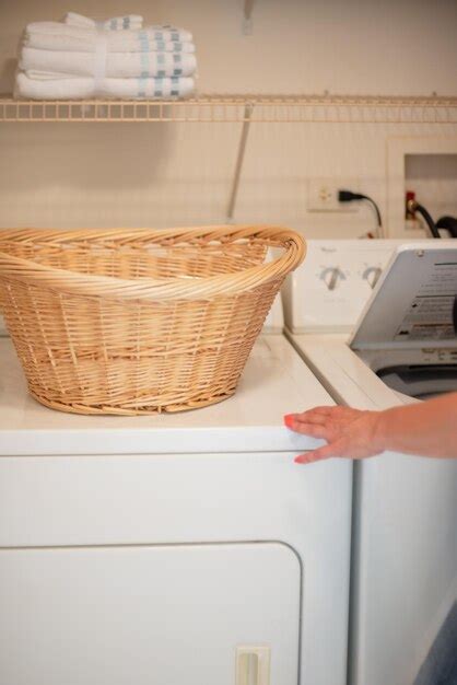 Premium Photo Cropped Hand Of Woman Using Washing Machine In Home