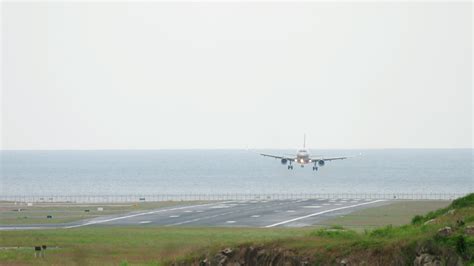 The plane landing at the resort. The airplane landing over the beach ...