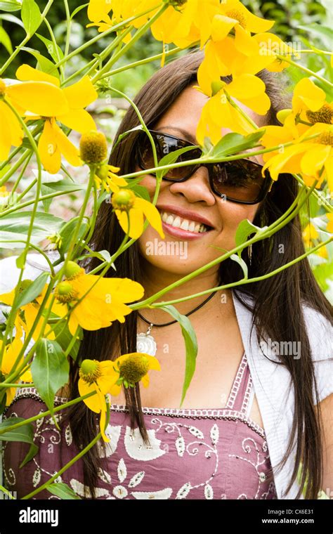 Smiling Filipina Wearing Designer Sunglasses Face Framed With Yellow