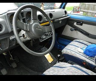 the interior of a small car with blue and gray cloth on the floor ...