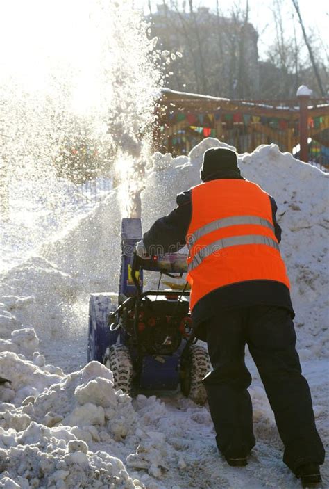 Man Cleans Snow With A Shovel Stock Photo Image Of Frozen Garden