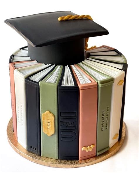 A Cake Decorated With Books And A Graduation Cap