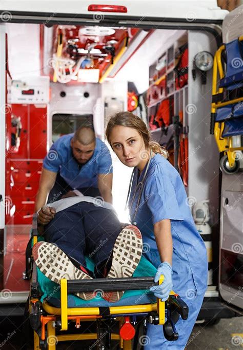 Ambulance Team Laying Patient On Stretcher Stock Image Image Of Auto