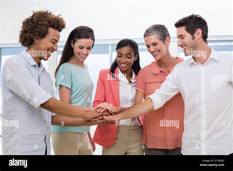 Casual Business Team Putting Hands Together Stock Photo Alamy