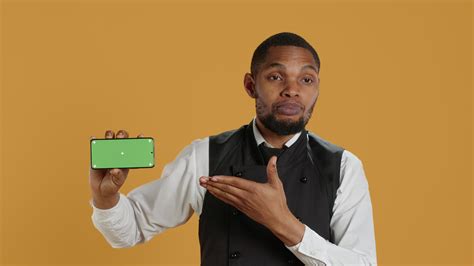 Waiter with professionalism holding a phone with isolated mockup