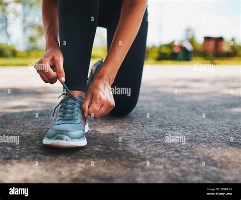 Time To Hit The Road An Unrecognizable Sportswoman Tying Her Shoelaces