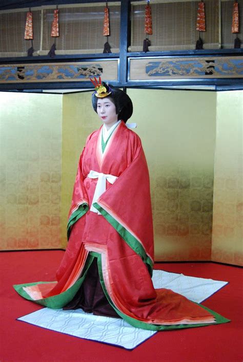 A Woman Being Dressed In Junihitoe Layer By Layer At A Kimono