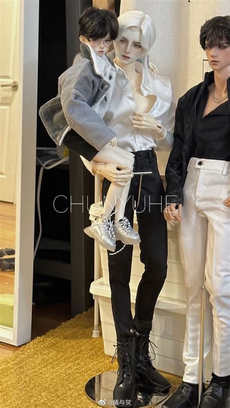 Two Mannequins Dressed In Black And White Are Standing Next To Each Other