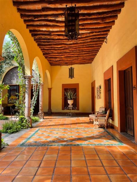 an outdoor area with tiled floors and orange walls