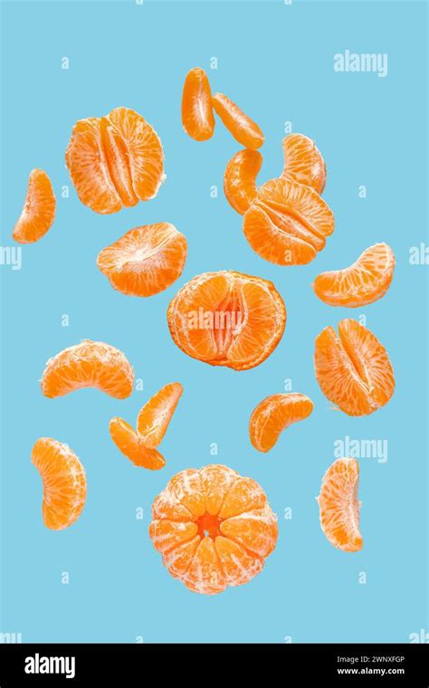 Flying Sweet Peeled Mandarins On Blue Background Stock Photo Alamy