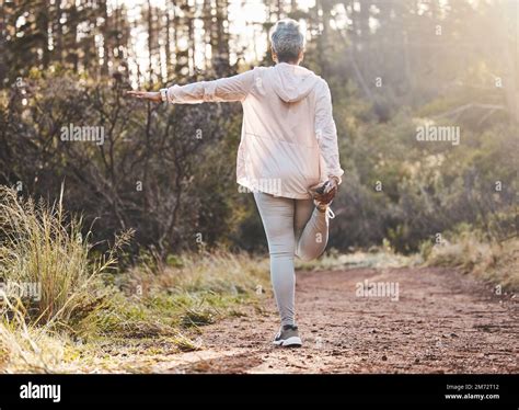 Fitness Forest Or Senior Woman Stretching In Nature To Start Training