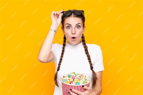 Premium Photo Girl Eating Popcorn While Watching A Movie Over