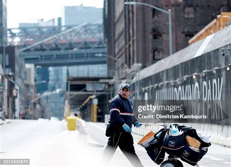 A United States mail carrier is seen delivering mail as the... News ...