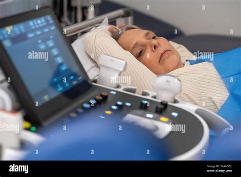 A Patient Is Undergoing An Ultrasound Exam With A Sonography Machine