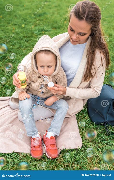 Little Boy Inflates Air Bubbles Woman Plays With Child Summer Green