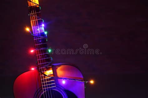 Acoustic Guitar with Christmas Lights Against Dark Background Stock ...