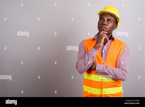 Young African Man Construction Worker Against White Background Stock