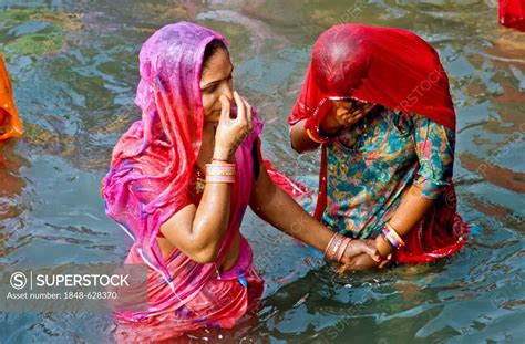 Two Women Taking Bath At Har Ki Pauri Ghat The Famous Bathing Ghat In