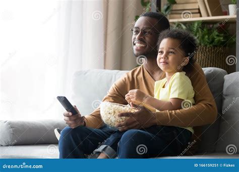 Happy Black Father And Son Watch Tv Eating Popcorn Stock Image Image