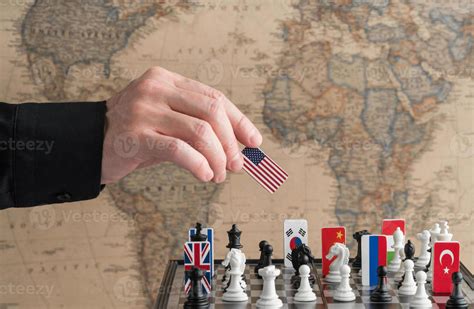 Politicians Hand Moves A Chess Piece With A Flag Conceptual Photo Of