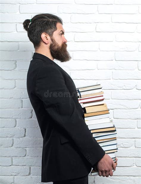 Portrait Of A Funny Teacher Or Professor With Book Stack Thinking Serious Mature Teacher Stock