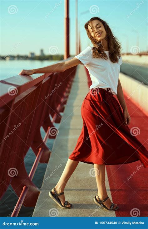 Bright Lifestyle Portrait Of Young Pretty Woman In Red Skirt And White