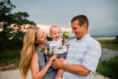 family-poses_toddler-holding-flowers-held-by-parents-larissa-lord ...