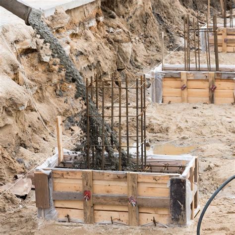 The Process Of Pouring Concrete Into The Formwork With Rebar