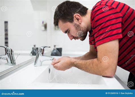 Man Washing His Face In The Bathroom Washbasin Stock Photo Image Of