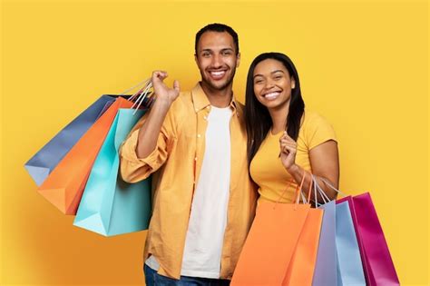 Premium Photo Cheerful Millennial African American Guy And Woman Hold