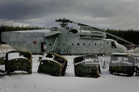 Highly Radiated Vehicles Lay In A Row In Front Of A Helicopter Used