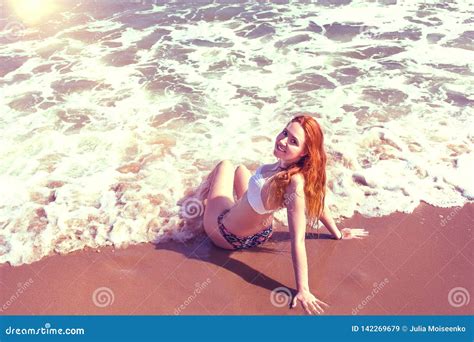 Beautiful Girl In Bikini Posing On A Deserted Beach White Sand