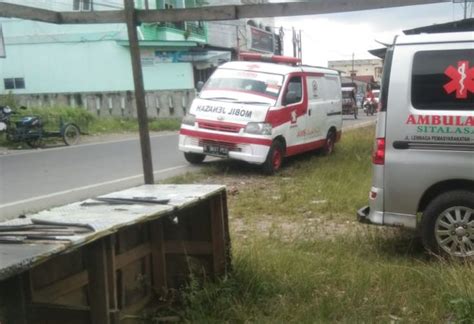 Two Ambulances Parked Next To Each Other In The Grass