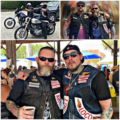 Two Men In Leather Jackets And Sunglasses Posing For Pictures With