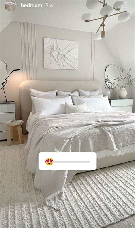 A Bedroom With White Bedding And Pillows