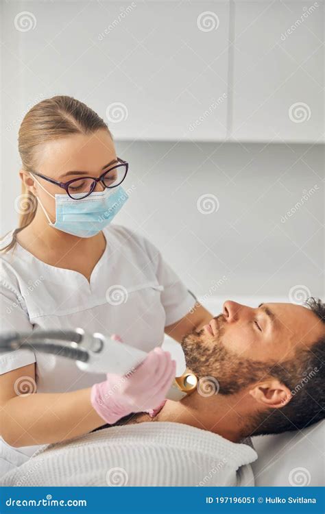 Female Esthetician Performing Laser Hair Removal Procedure Stock Image