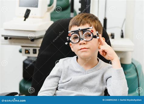 Cheerful Child Boy In Glasses Checks Eye Vision Pediatric