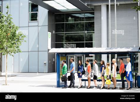 People waiting at bus stop Stock Photo - Alamy