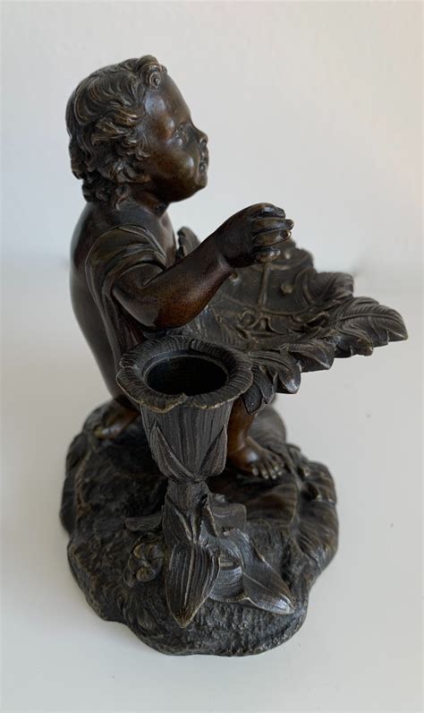 Petit bronze représentant un putto 2R Antiquites