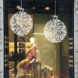 a store window display with ornaments hanging from it's windows