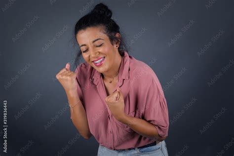 Caucasian Brunette Woman Rejoicing Her Success And Victory Clenching Her Fists With Joy Lucky