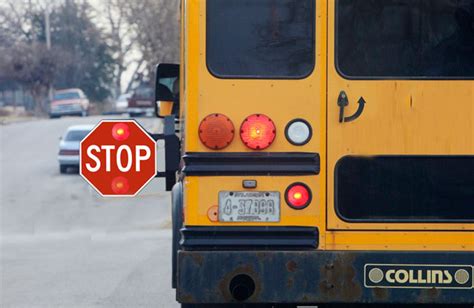 School bus with flashing red lights and extended stop arm - Free DMV Test