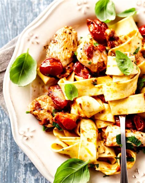 Tagliatelle Pasta With Grilled Chicken Fillet And Cherry Tomatoes Stock