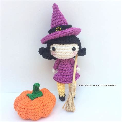 A Crocheted Doll Next To An Orange Pumpkin