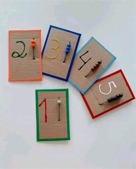 Four Pieces Of Crafting Paper With Numbers And Pins Laid Out On Top Of