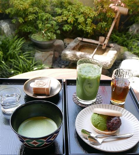 A Table Topped With Plates And Bowls Filled With Food Next To Cups Full